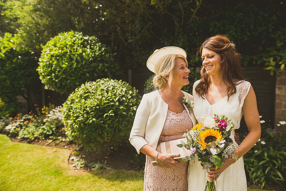 Ashleigh wore an elegant Charlie Brear gown for her sunshine and sunflower filled wedding. A Mariachi band entertained guests at the reception. Bridesmaids wore ASOS. Photography by The Springles.