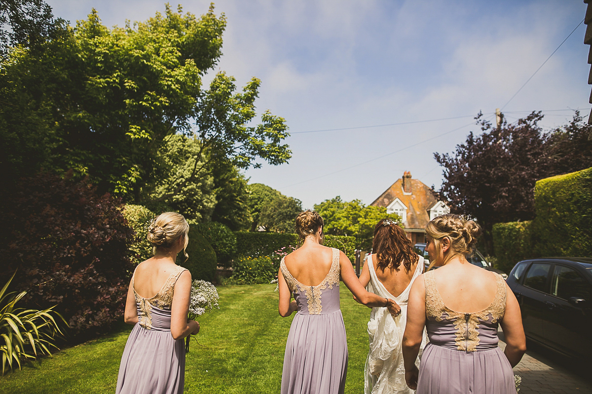 Ashleigh wore an elegant Charlie Brear gown for her sunshine and sunflower filled wedding. A Mariachi band entertained guests at the reception. Bridesmaids wore ASOS. Photography by The Springles.