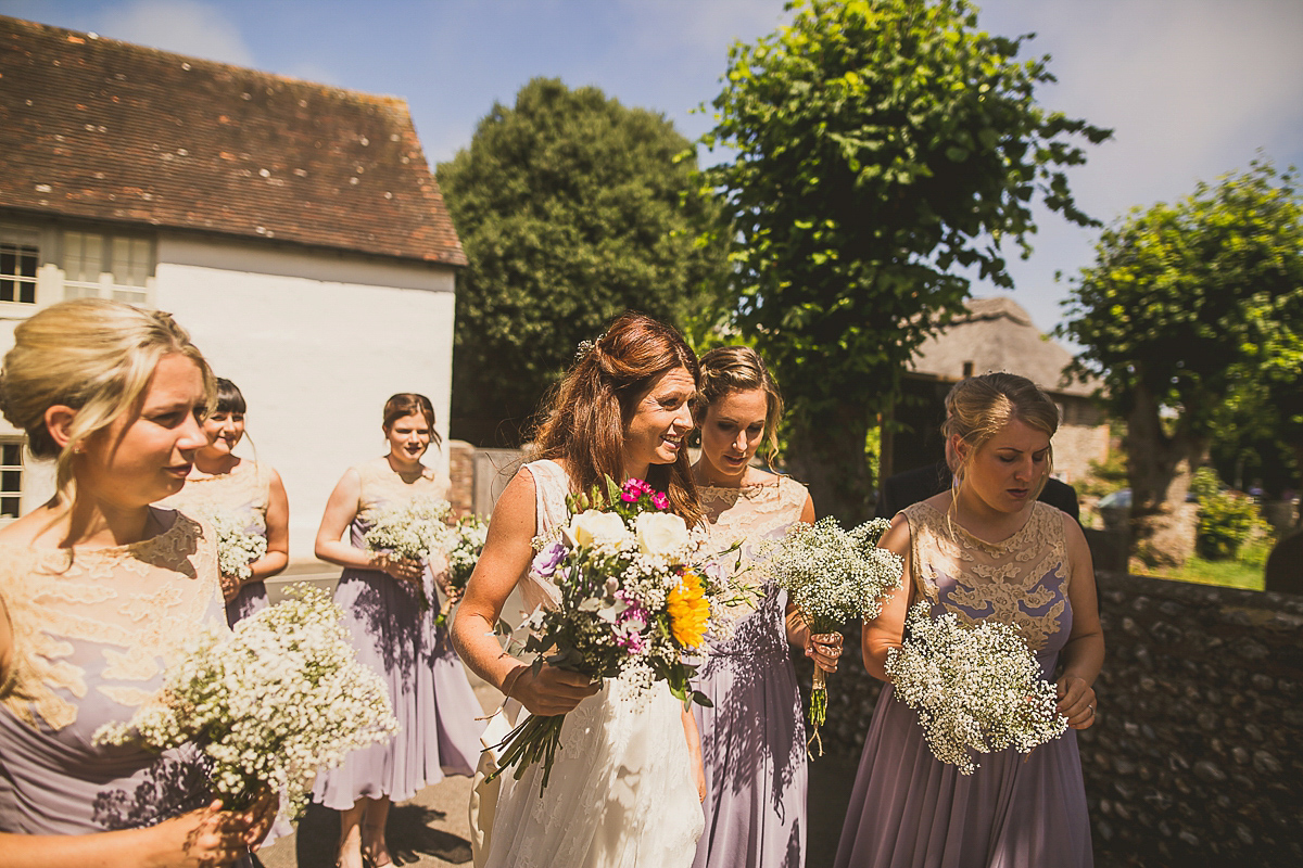 Ashleigh wore an elegant Charlie Brear gown for her sunshine and sunflower filled wedding. A Mariachi band entertained guests at the reception. Bridesmaids wore ASOS. Photography by The Springles.