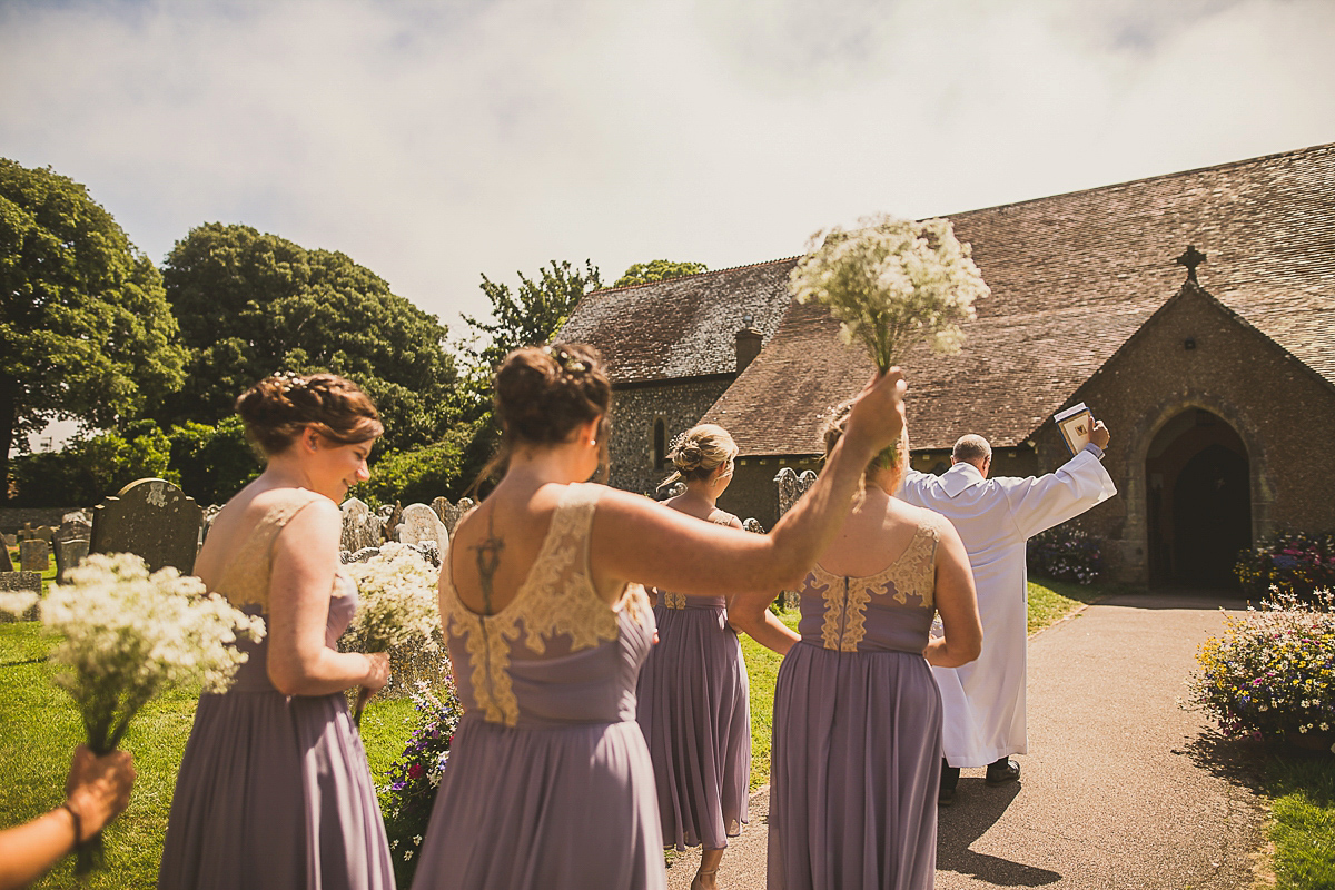 Ashleigh wore an elegant Charlie Brear gown for her sunshine and sunflower filled wedding. A Mariachi band entertained guests at the reception. Bridesmaids wore ASOS. Photography by The Springles.