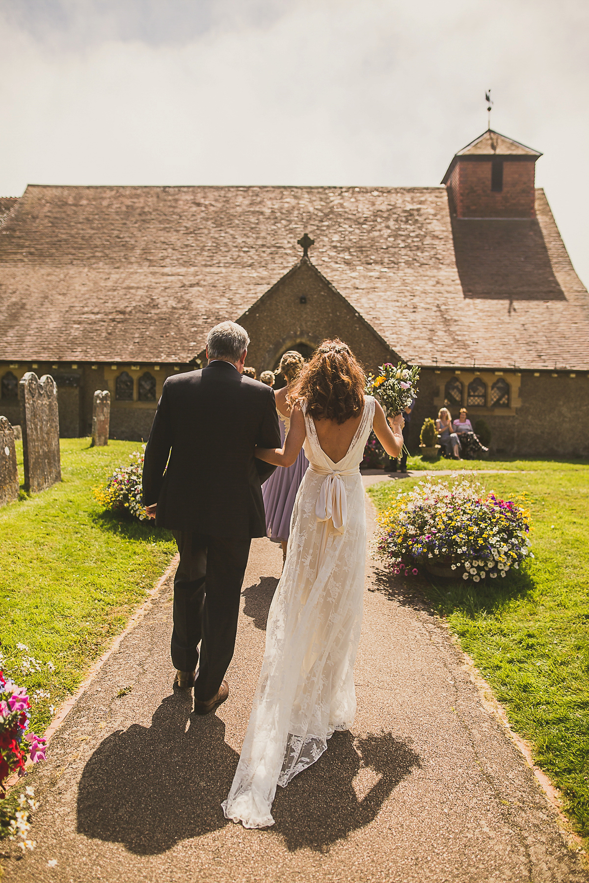 Ashleigh wore an elegant Charlie Brear gown for her sunshine and sunflower filled wedding. A Mariachi band entertained guests at the reception. Bridesmaids wore ASOS. Photography by The Springles.