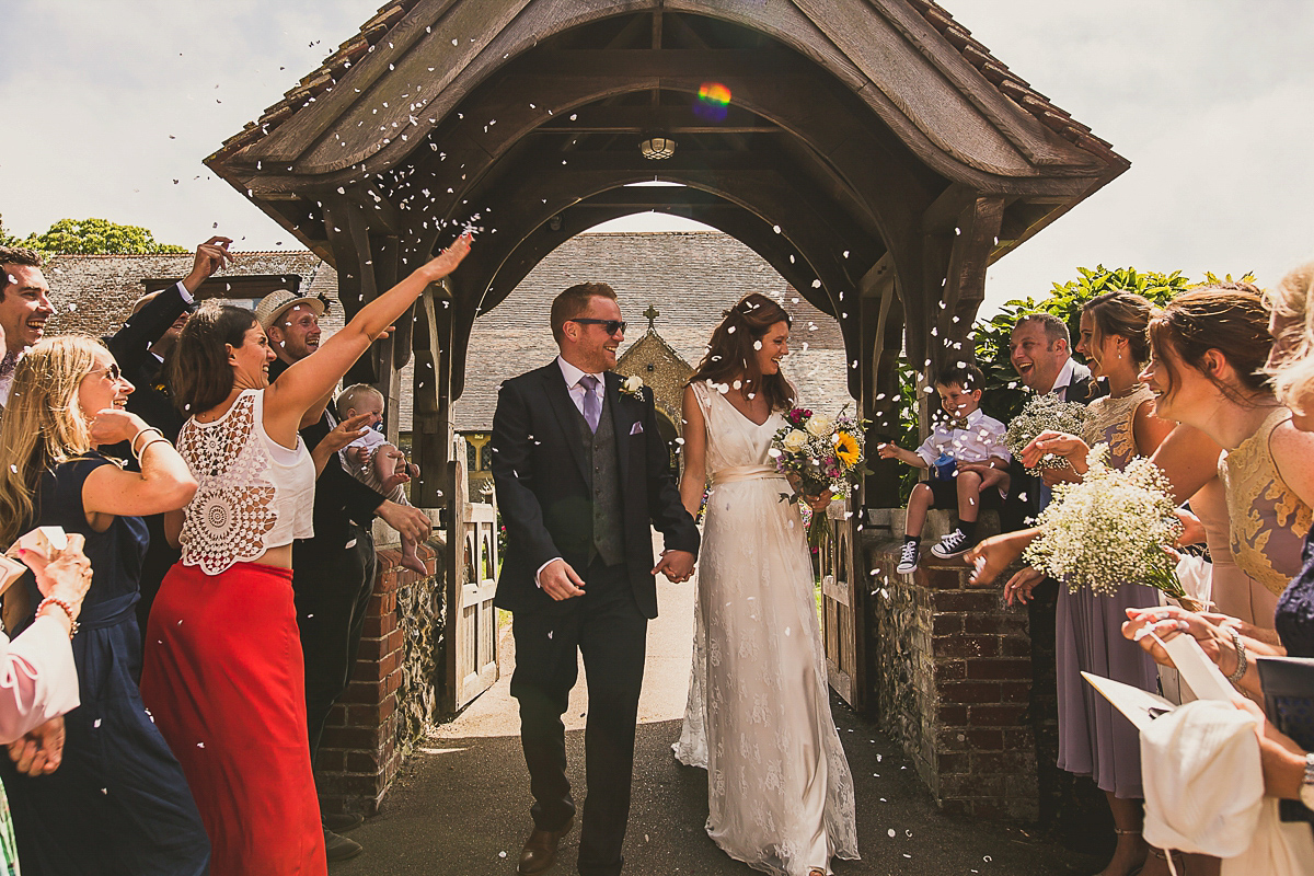 Ashleigh wore an elegant Charlie Brear gown for her sunshine and sunflower filled wedding. A Mariachi band entertained guests at the reception. Bridesmaids wore ASOS. Photography by The Springles.