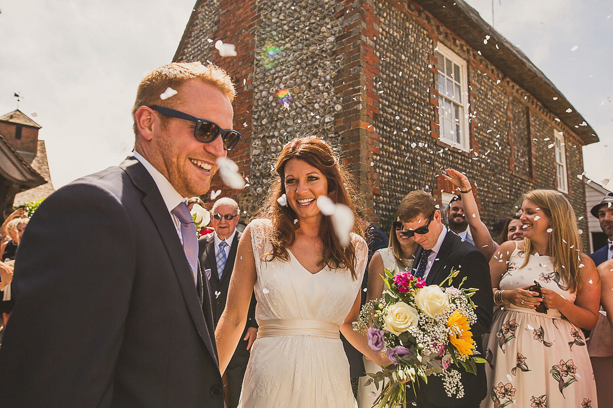 Ashleigh wore an elegant Charlie Brear gown for her sunshine and sunflower filled wedding. A Mariachi band entertained guests at the reception. Bridesmaids wore ASOS. Photography by The Springles.