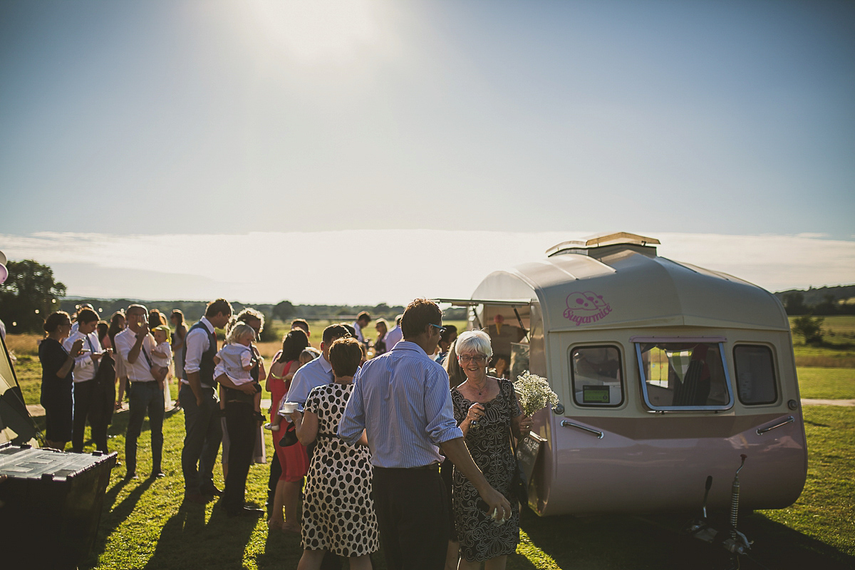 Ashleigh wore an elegant Charlie Brear gown for her sunshine and sunflower filled wedding. A Mariachi band entertained guests at the reception. Bridesmaids wore ASOS. Photography by The Springles.