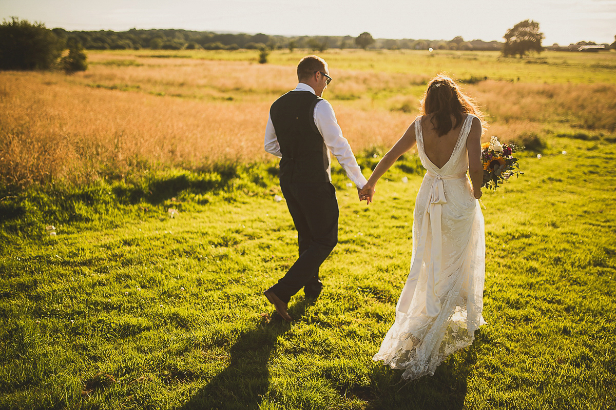 Ashleigh wore an elegant Charlie Brear gown for her sunshine and sunflower filled wedding. A Mariachi band entertained guests at the reception. Bridesmaids wore ASOS. Photography by The Springles.