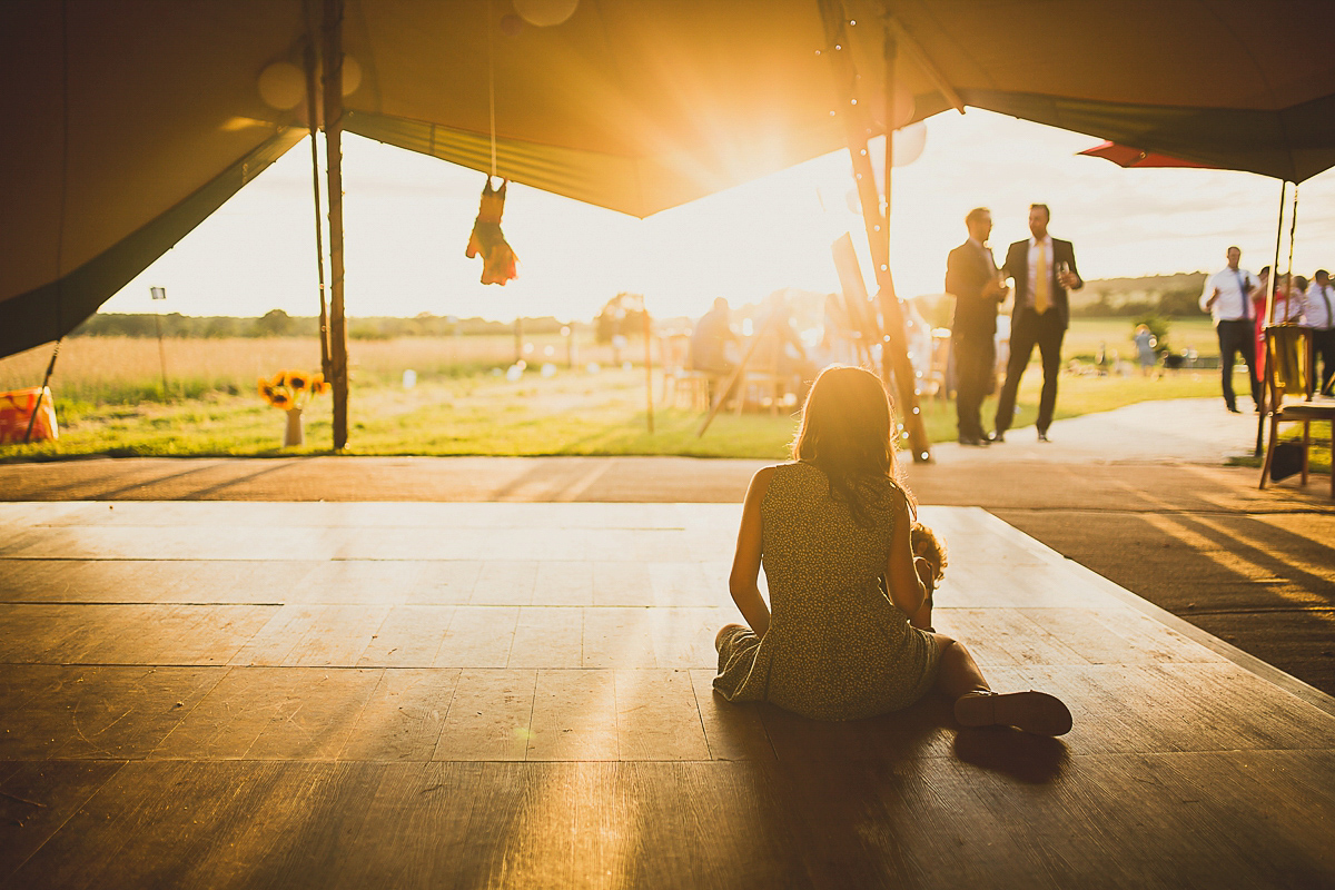 Ashleigh wore an elegant Charlie Brear gown for her sunshine and sunflower filled wedding. A Mariachi band entertained guests at the reception. Bridesmaids wore ASOS. Photography by The Springles.