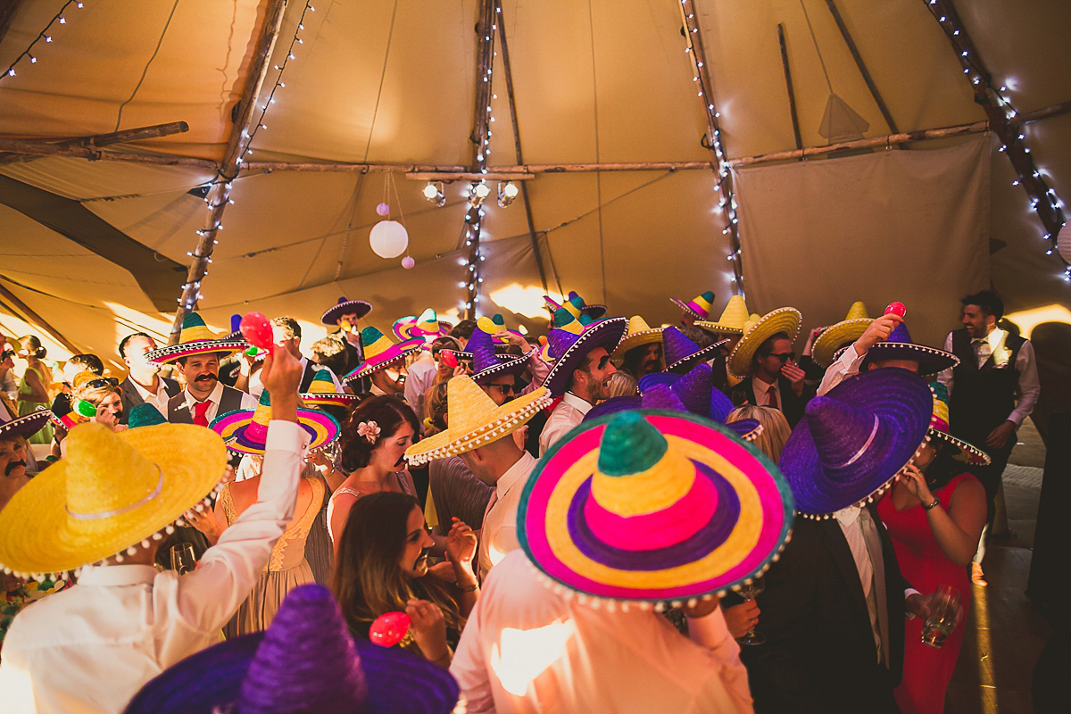 Ashleigh wore an elegant Charlie Brear gown for her sunshine and sunflower filled wedding. A Mariachi band entertained guests at the reception. Bridesmaids wore ASOS. Photography by The Springles.