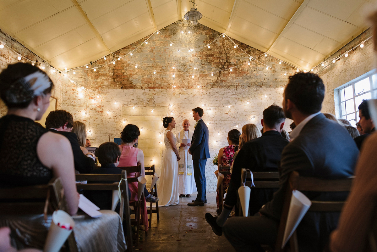 Ruth wore a J.Crew dress for her modern, cool, London warehouse wedding. Photography by Thierry Joubert.