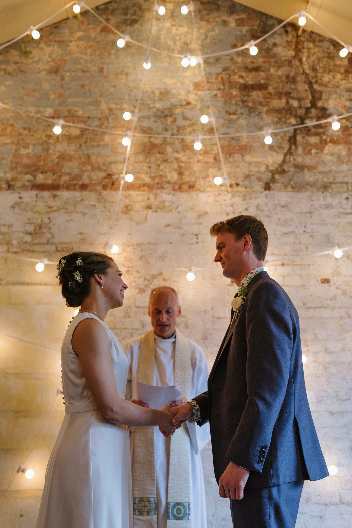 Ruth wore a J.Crew dress for her modern, cool, London warehouse wedding. Photography by Thierry Joubert.