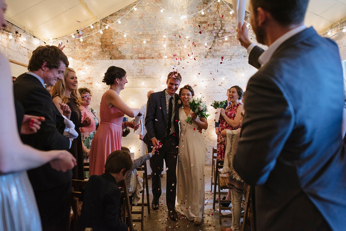 Ruth wore a J.Crew dress for her modern, cool, London warehouse wedding. Photography by Thierry Joubert.