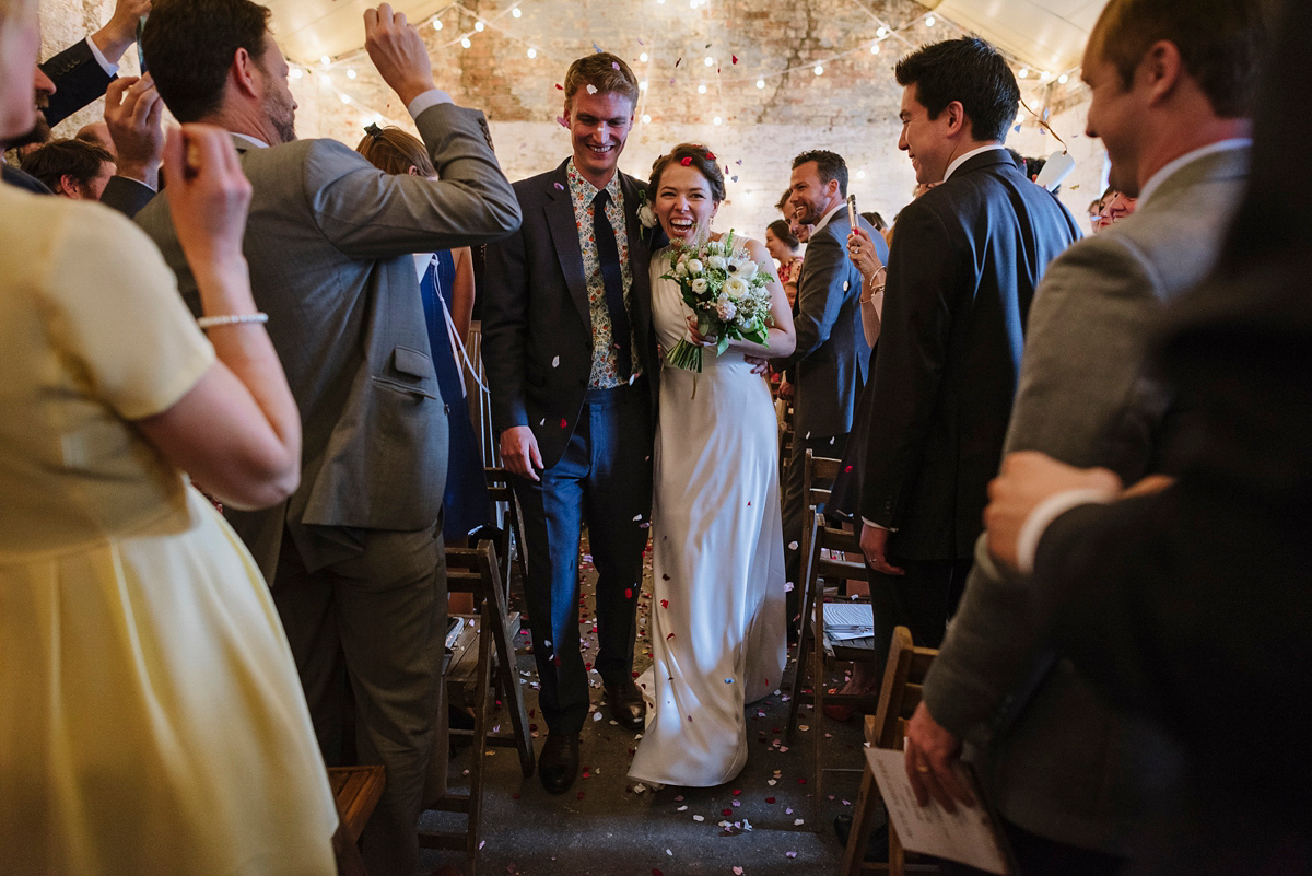 Ruth wore a J.Crew dress for her modern, cool, London warehouse wedding. Photography by Thierry Joubert.