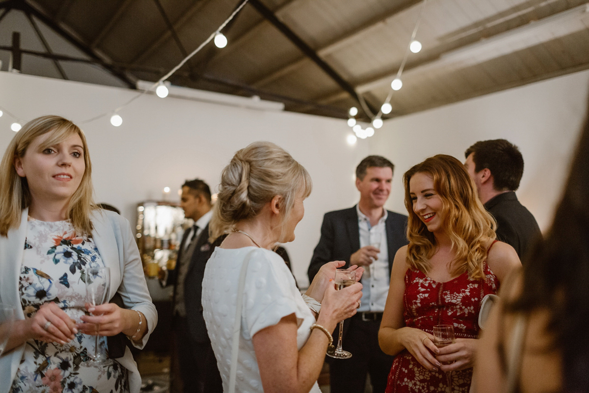 Katie wore a For Love & Lemons dress for her cool, modern, warehouse wedding in Glasgow. Photography by The Curries.