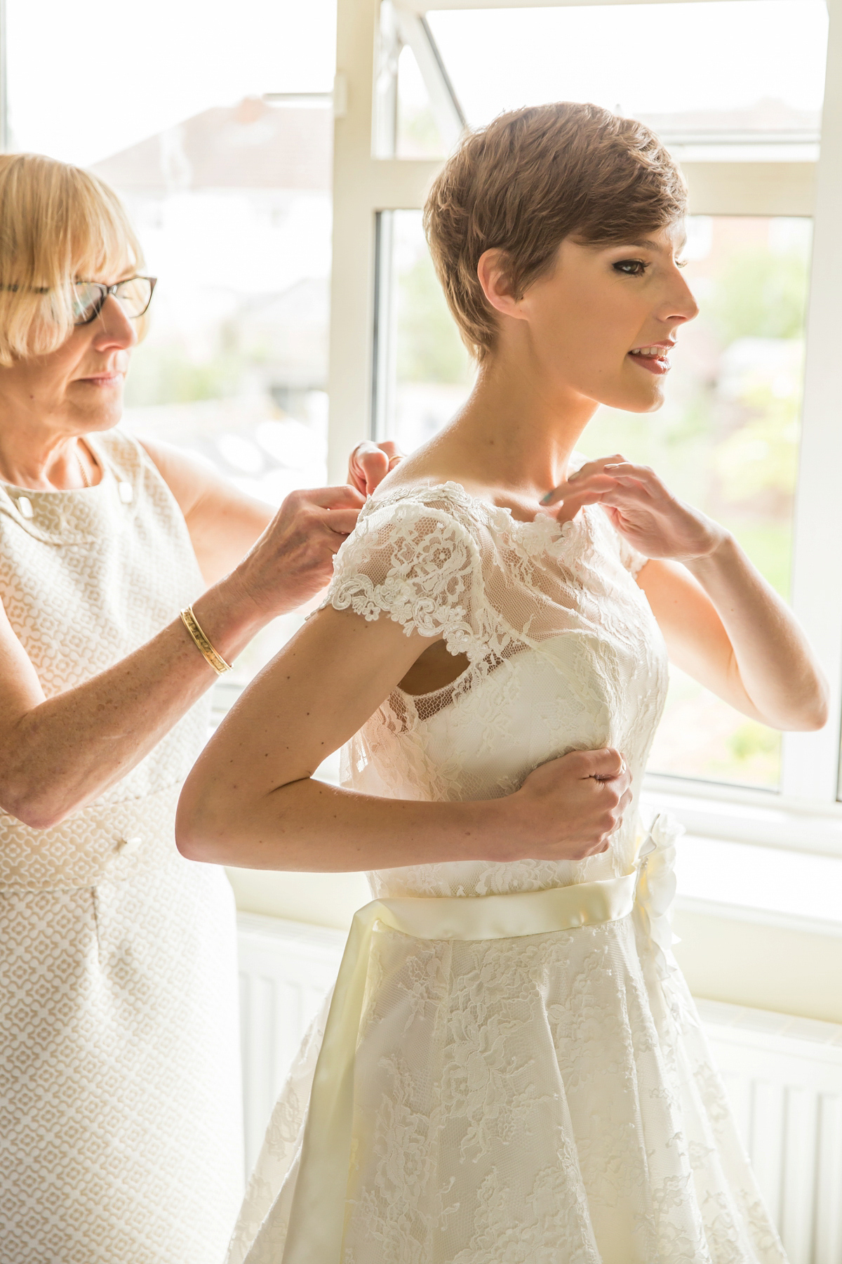 Jo wore a retro inspired Sassi Holford gown from Ellie Sanderson bridal boutique and a pair of Charlotte Mills shoes for her 'silent disco' wedding. Photography by Hannah Larkin.