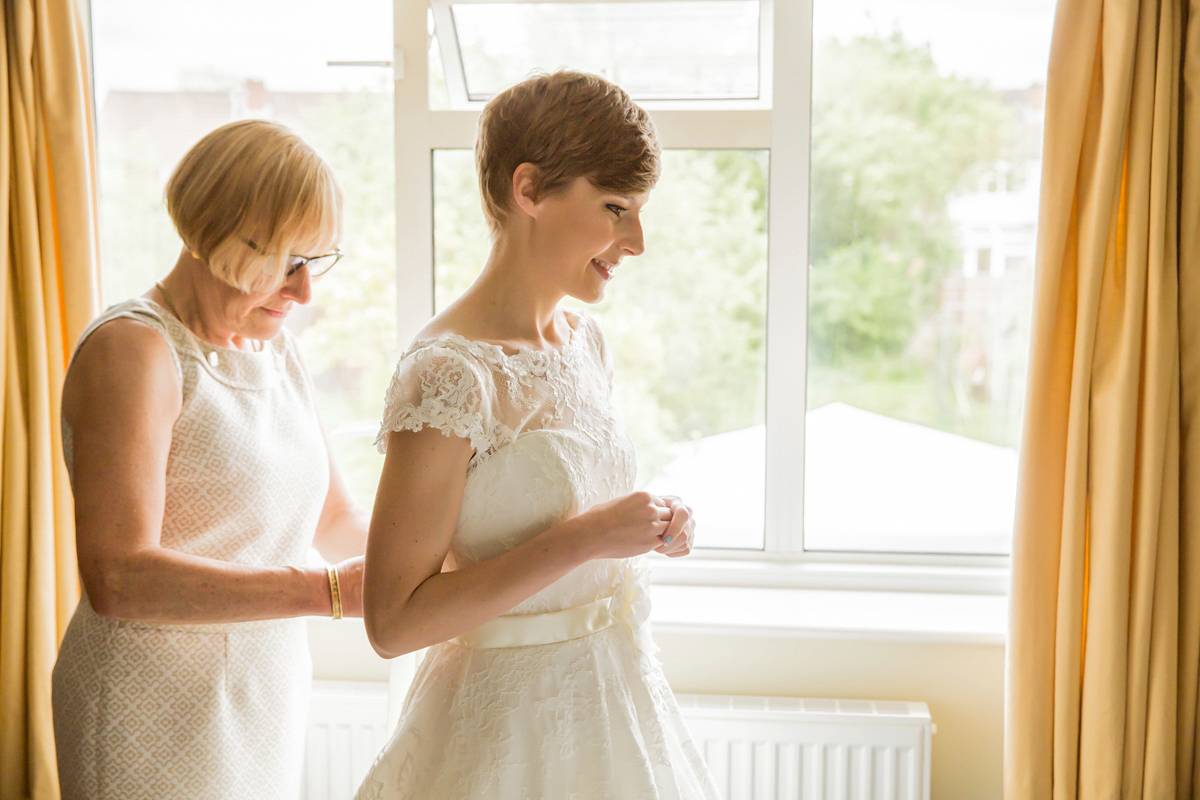 Jo wore a retro inspired Sassi Holford gown from Ellie Sanderson bridal boutique and a pair of Charlotte Mills shoes for her 'silent disco' wedding. Photography by Hannah Larkin.