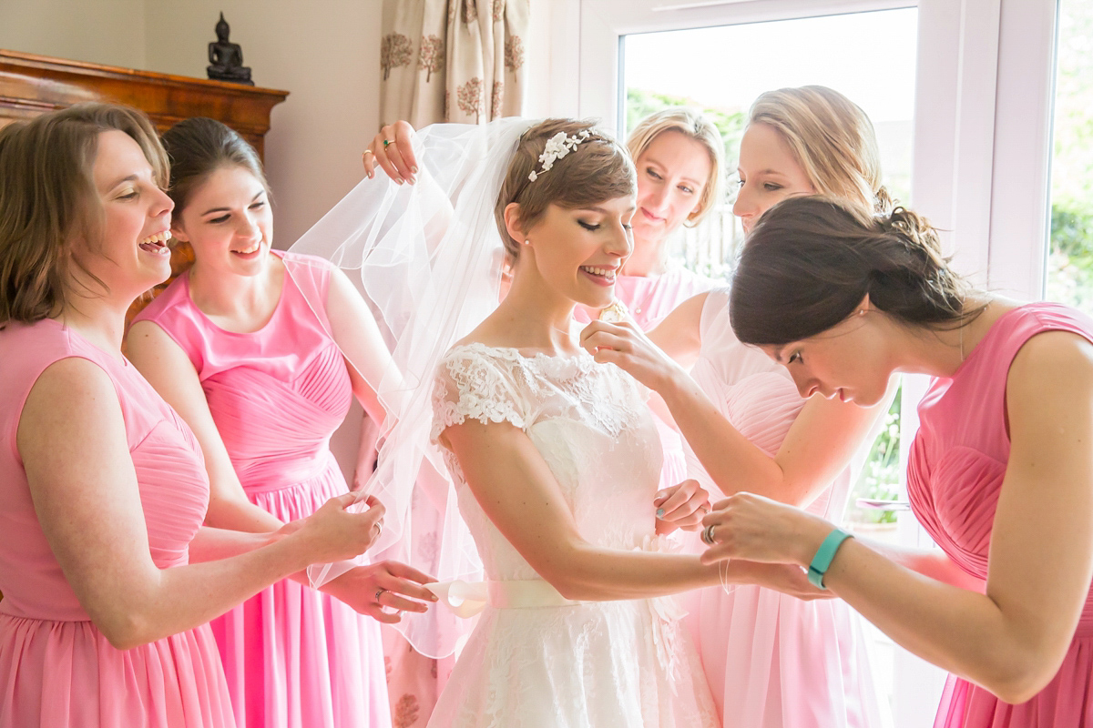 Jo wore a retro inspired Sassi Holford gown from Ellie Sanderson bridal boutique and a pair of Charlotte Mills shoes for her 'silent disco' wedding. Photography by Hannah Larkin.