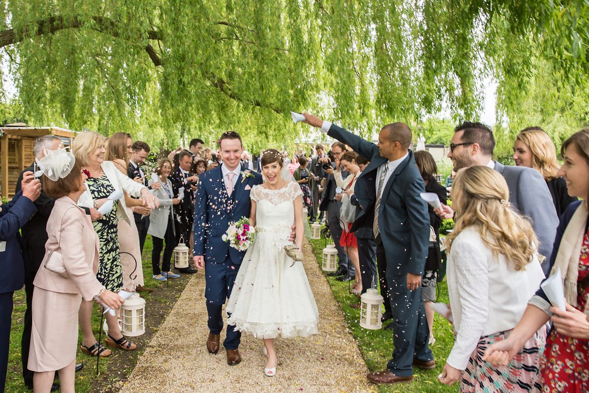 Jo wore a retro inspired Sassi Holford gown from Ellie Sanderson bridal boutique and a pair of Charlotte Mills shoes for her 'silent disco' wedding. Photography by Hannah Larkin.