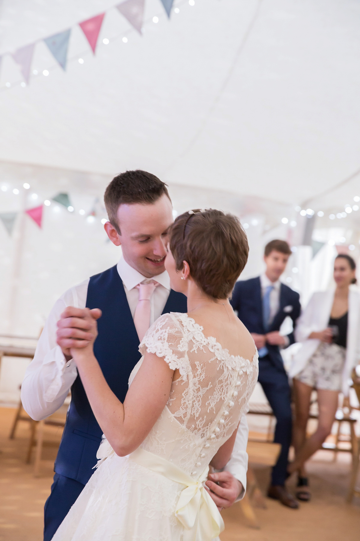 Jo wore a retro inspired Sassi Holford gown from Ellie Sanderson bridal boutique and a pair of Charlotte Mills shoes for her 'silent disco' wedding. Photography by Hannah Larkin.