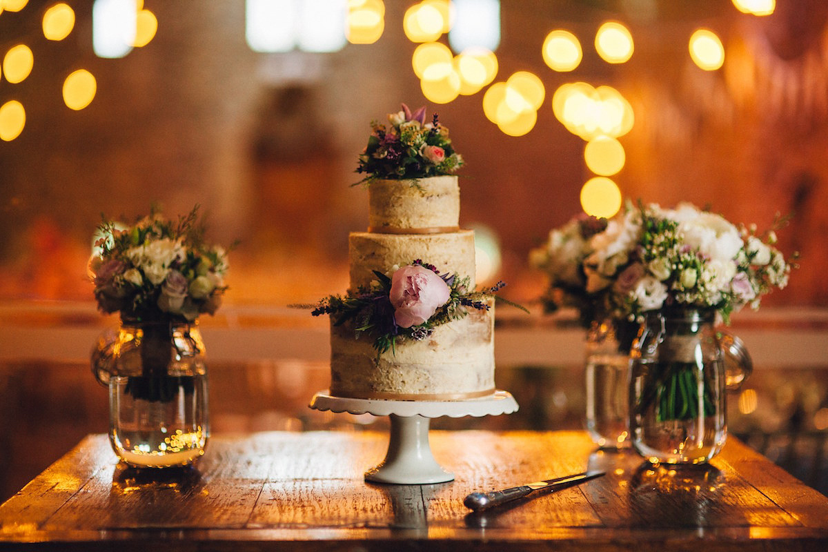 Caroline wore a Martina Liana gown for her elegant rainy day barn wedding. Images captured by Red On Blonde Photography.