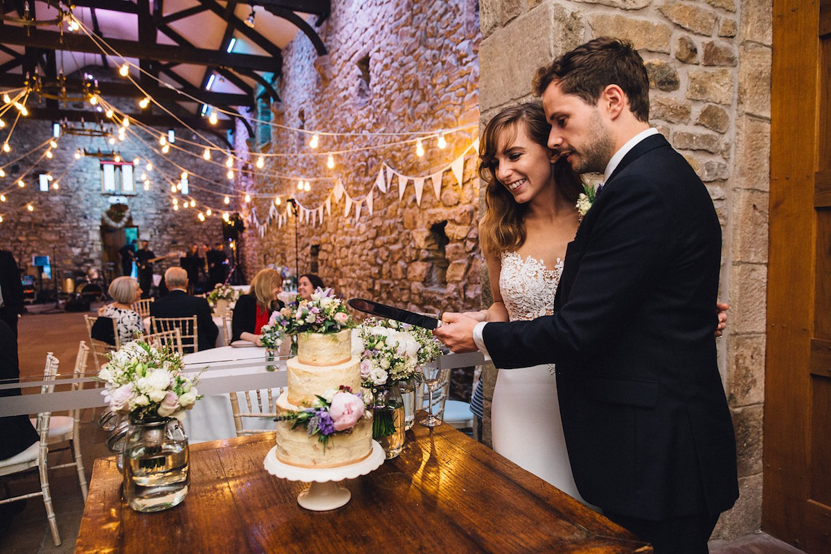 Caroline wore a Martina Liana gown for her elegant rainy day barn wedding. Images captured by Red On Blonde Photography.