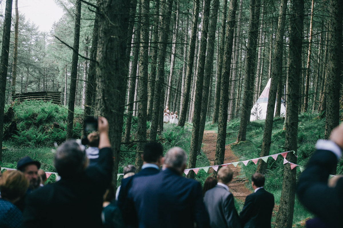 Sarah wore a 1950's inspired tea length wedding dress for her woodland wedding in Scotland. Images captured by Mirrorbox Photography.