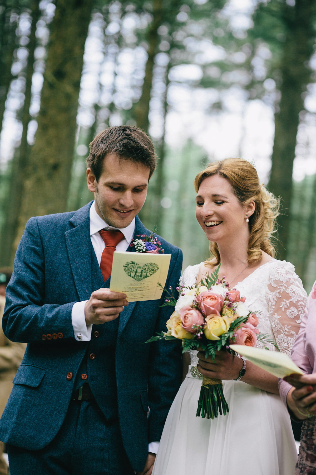 Sarah wore a 1950's inspired tea length wedding dress for her woodland wedding in Scotland. Images captured by Mirrorbox Photography.