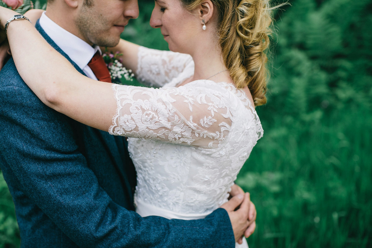 Sarah wore a 1950's inspired tea length wedding dress for her woodland wedding in Scotland. Images captured by Mirrorbox Photography.