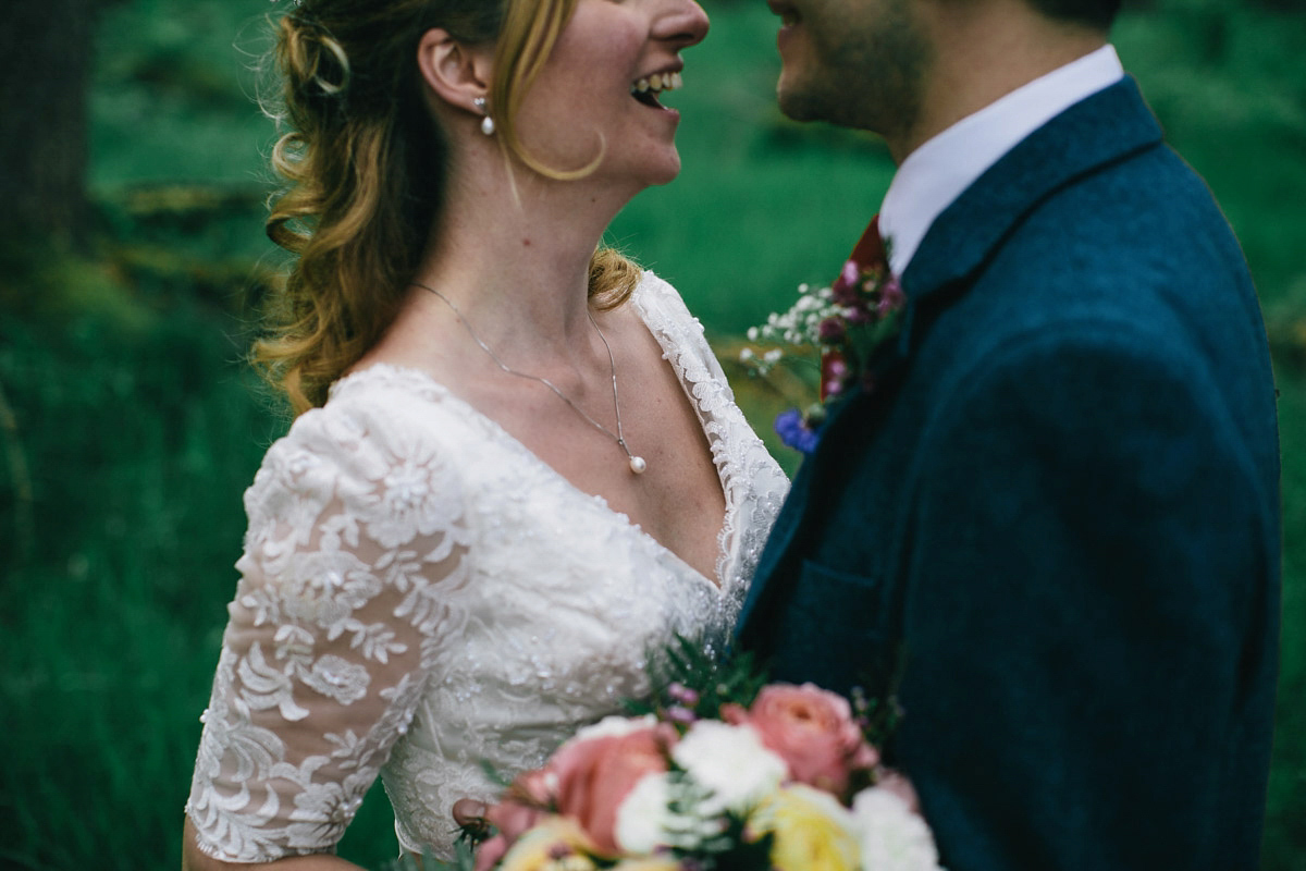 Sarah wore a 1950's inspired tea length wedding dress for her woodland wedding in Scotland. Images captured by Mirrorbox Photography.