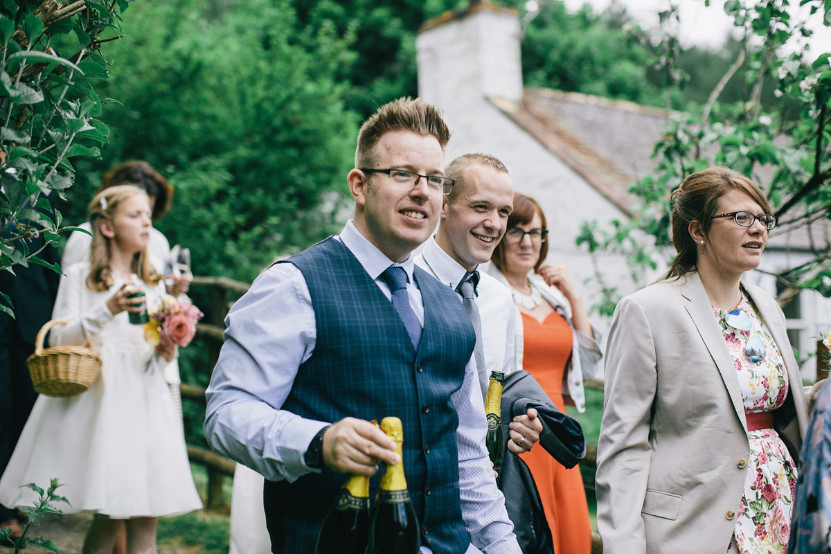 Sarah wore a 1950's inspired tea length wedding dress for her woodland wedding in Scotland. Images captured by Mirrorbox Photography.