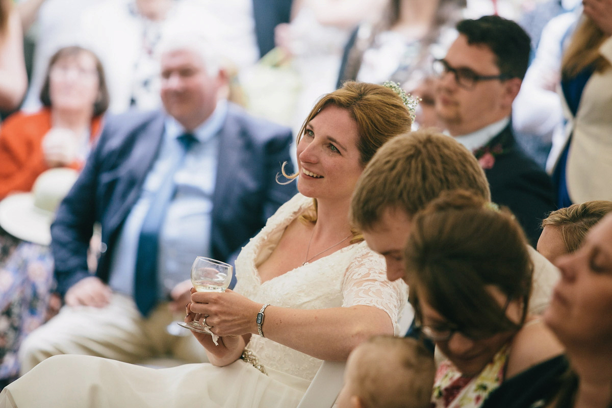 Sarah wore a 1950's inspired tea length wedding dress for her woodland wedding in Scotland. Images captured by Mirrorbox Photography.