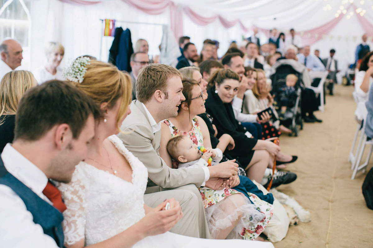 Sarah wore a 1950's inspired tea length wedding dress for her woodland wedding in Scotland. Images captured by Mirrorbox Photography.