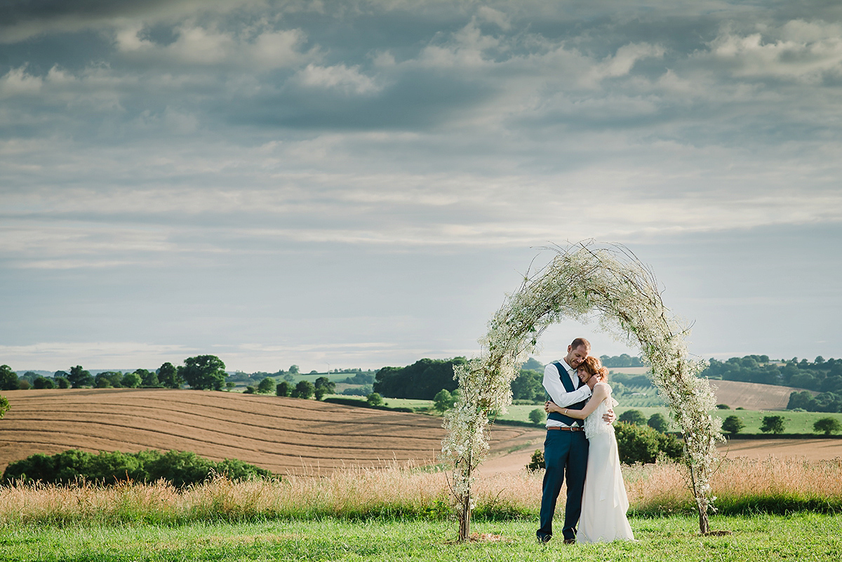 Posie wore a Delphine Manivet gown for her rustic, handmade, outdoor handfasting ceremony, captured by Amy Taylor Imaging.