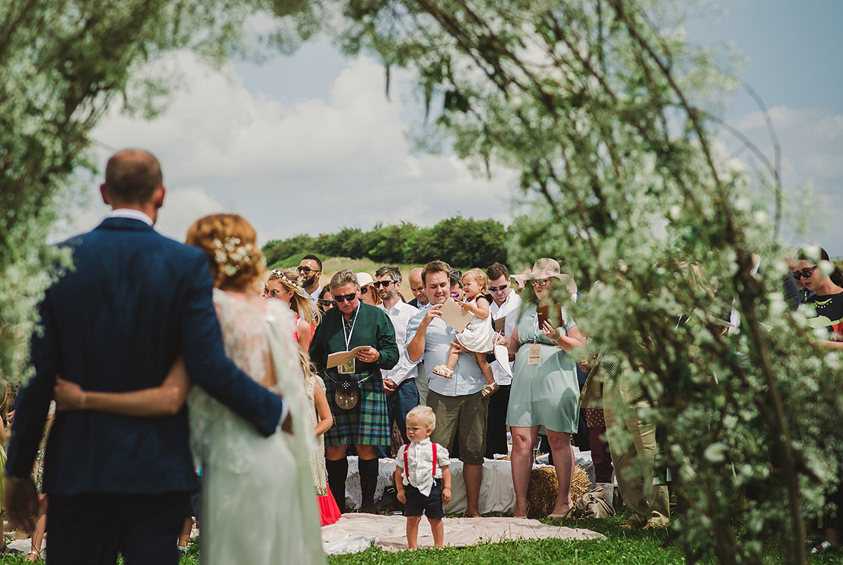 Posie wore a Delphine Manivet gown for her rustic, handmade, outdoor handfasting ceremony, captured by Amy Taylor Imaging.