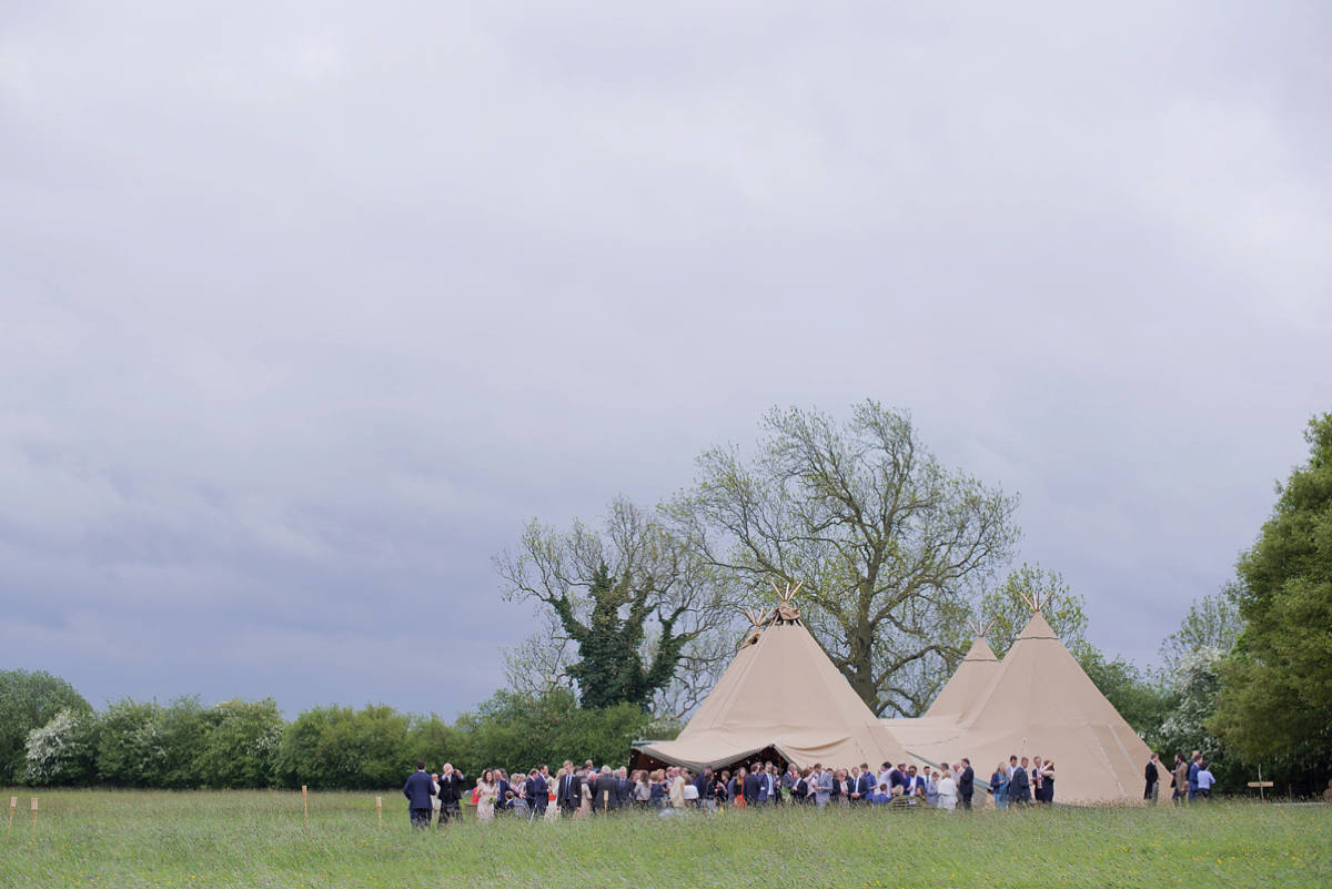 Connie wore a black leather jacket and dress by Belle & Bunty for her English wildfllower meadow inspired wedding. Photography by Emma Sekhonn.