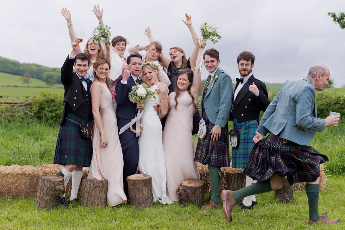 Connie wore a black leather jacket and dress by Belle & Bunty for her English wildfllower meadow inspired wedding. Photography by Emma Sekhonn.