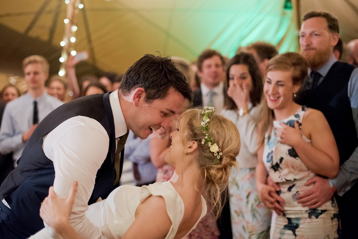 Connie wore a black leather jacket and dress by Belle & Bunty for her English wildfllower meadow inspired wedding. Photography by Emma Sekhonn.