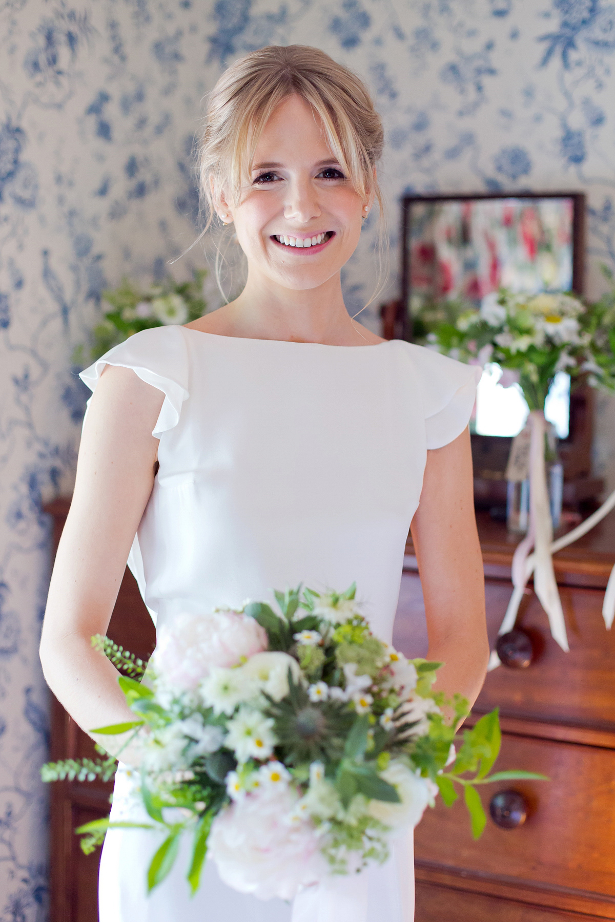 Connie wore a black leather jacket and dress by Belle & Bunty for her English wildfllower meadow inspired wedding. Photography by Emma Sekhonn.