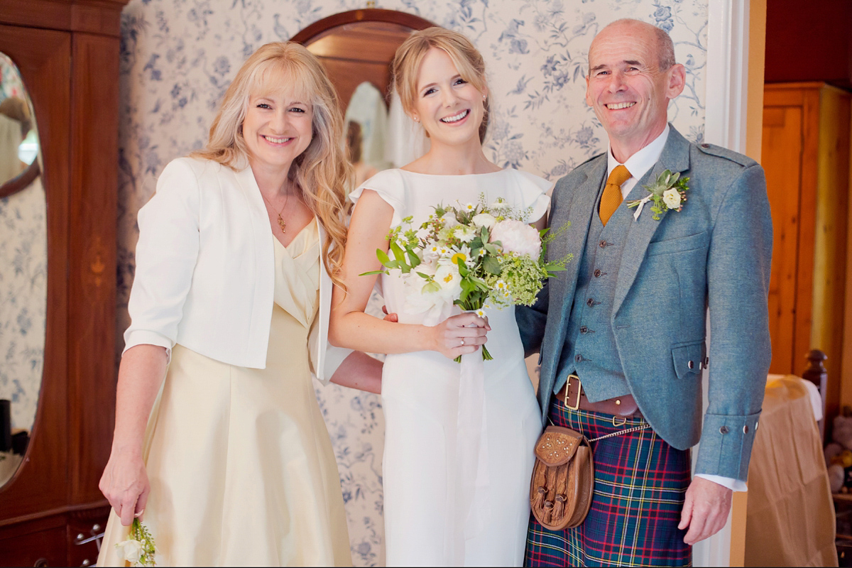 Connie wore a black leather jacket and dress by Belle & Bunty for her English wildfllower meadow inspired wedding. Photography by Emma Sekhonn.