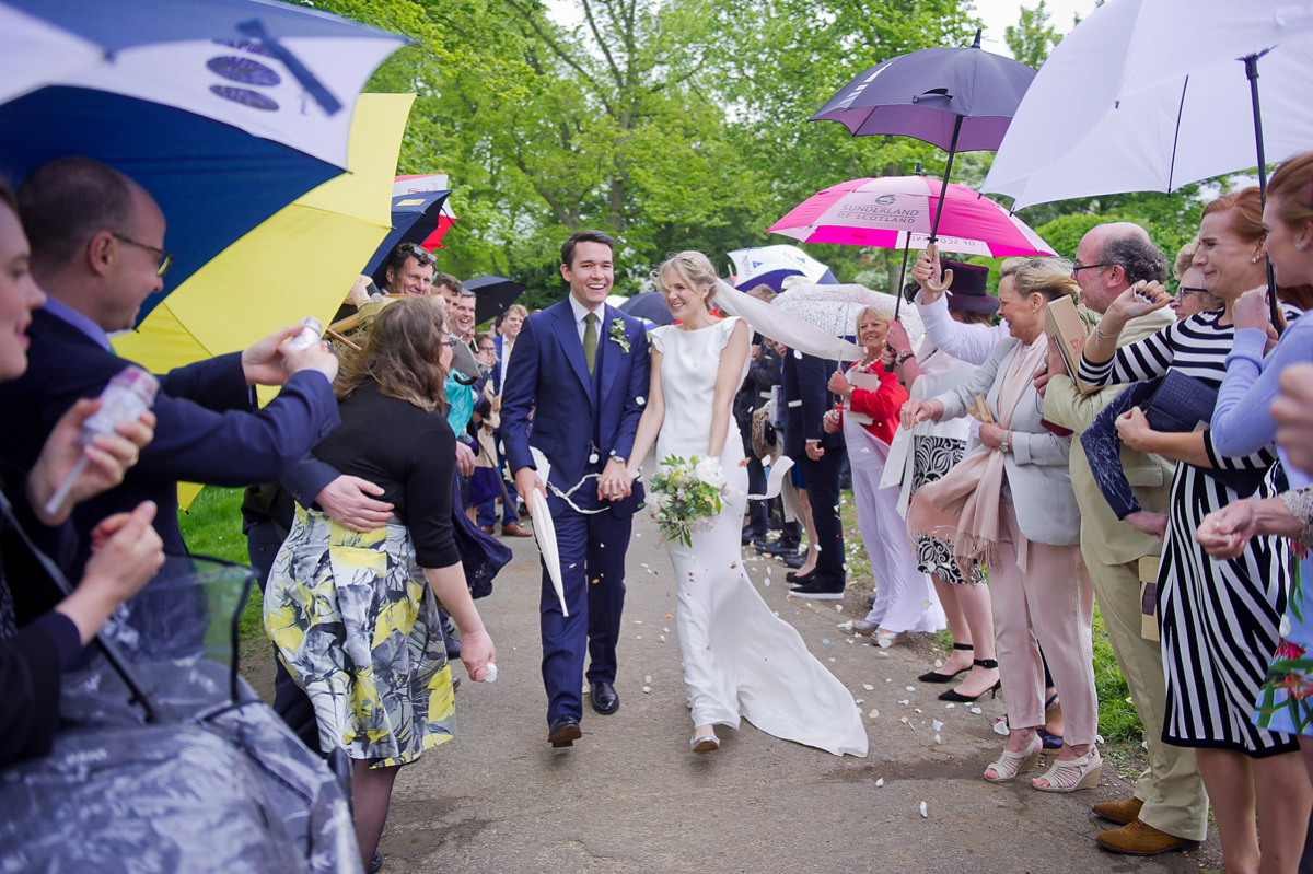 Connie wore a black leather jacket and dress by Belle & Bunty for her English wildfllower meadow inspired wedding. Photography by Emma Sekhonn.