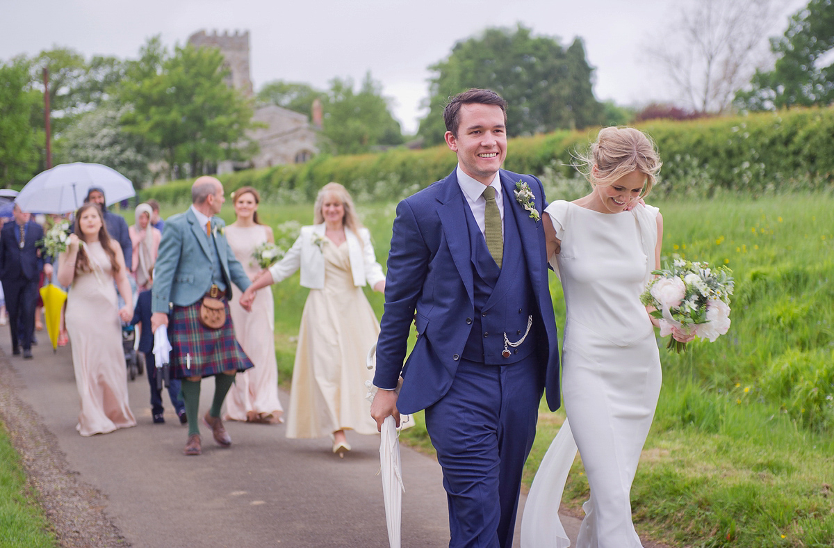 Connie wore a black leather jacket and dress by Belle & Bunty for her English wildfllower meadow inspired wedding. Photography by Emma Sekhonn.