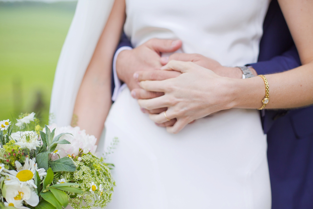 Connie wore a black leather jacket and dress by Belle & Bunty for her English wildfllower meadow inspired wedding. Photography by Emma Sekhonn.