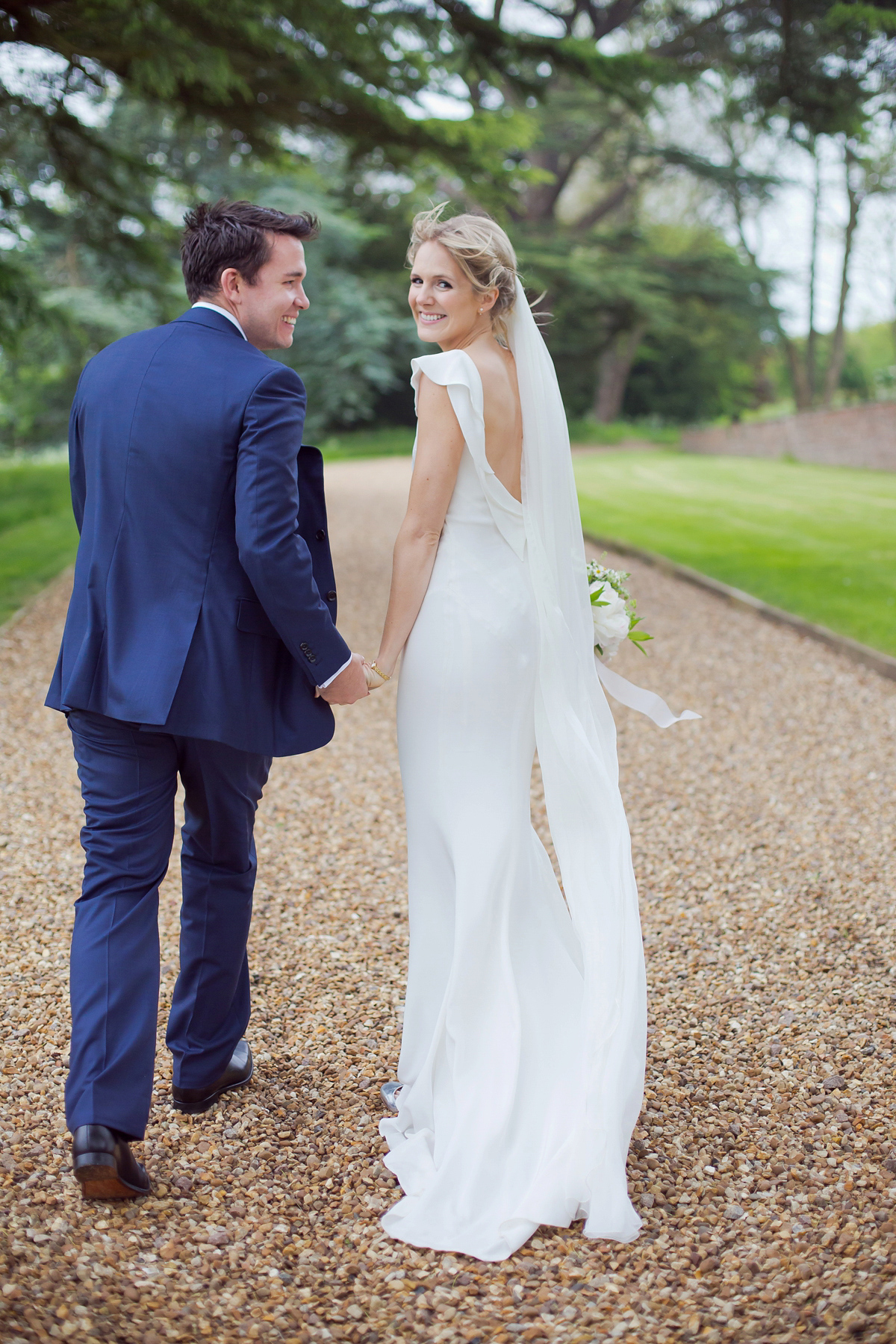 Connie wore a black leather jacket and dress by Belle & Bunty for her English wildfllower meadow inspired wedding. Photography by Emma Sekhonn.