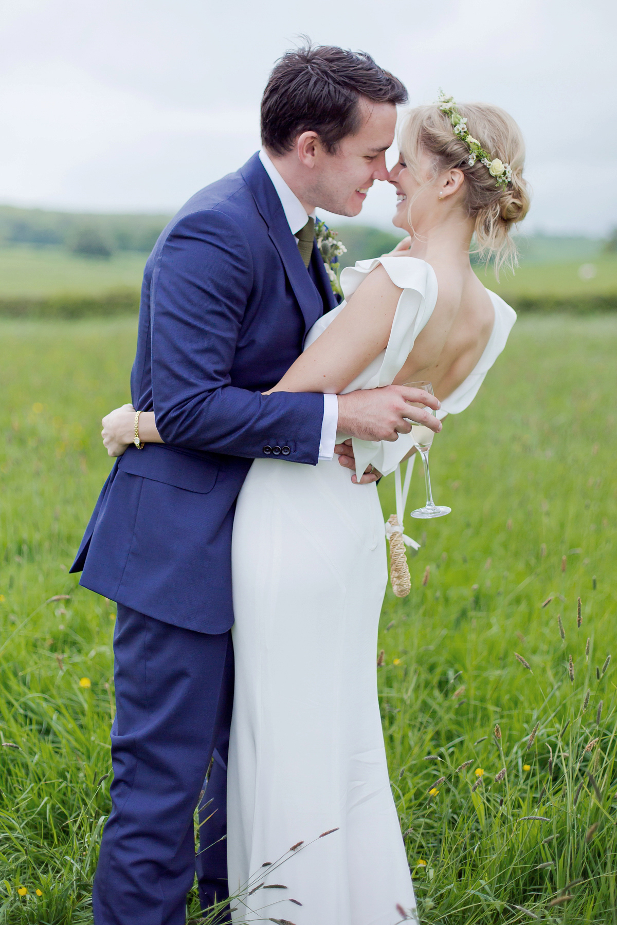 Connie wore a black leather jacket and dress by Belle & Bunty for her English wildfllower meadow inspired wedding. Photography by Emma Sekhonn.