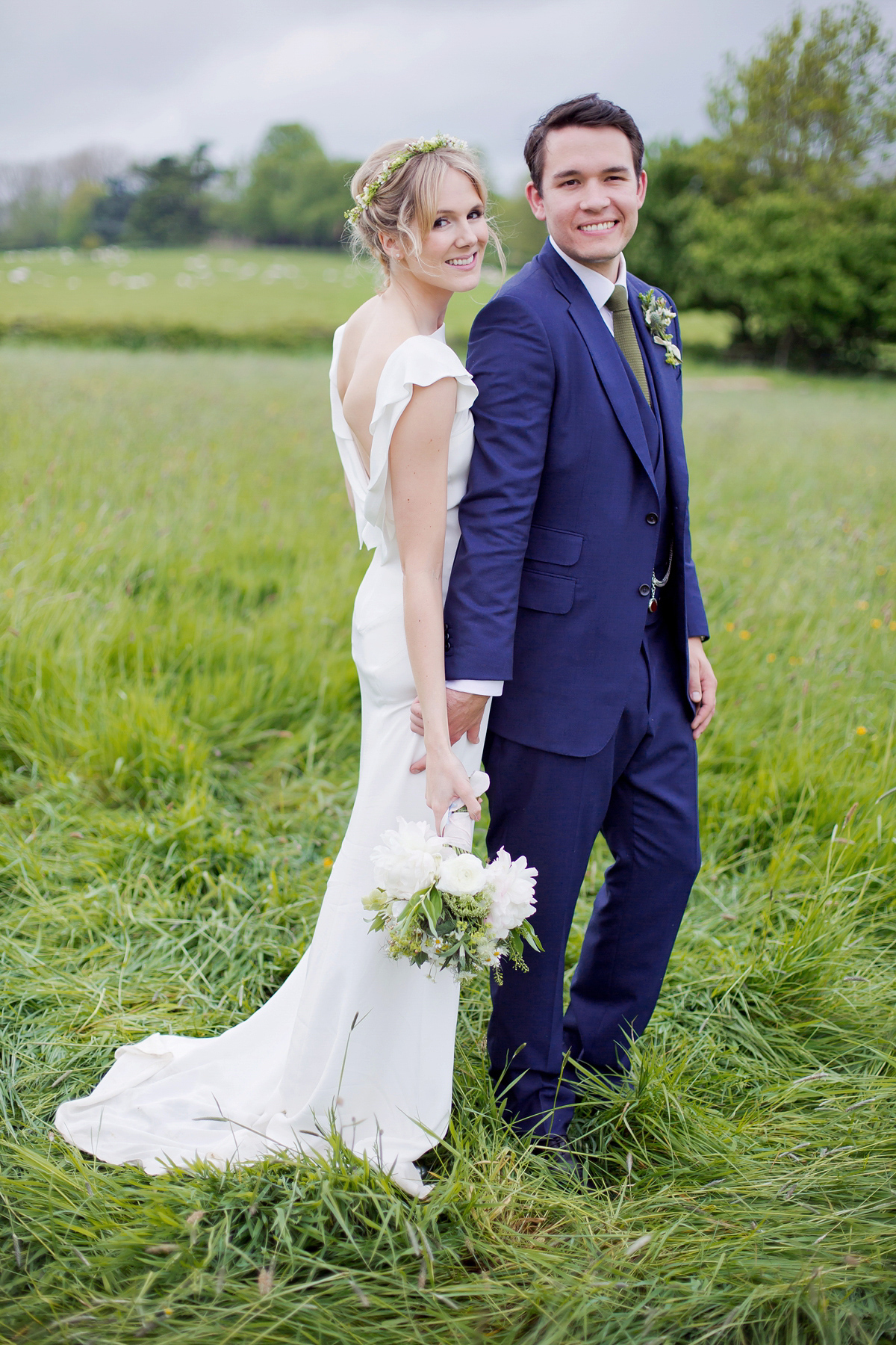 Connie wore a black leather jacket and dress by Belle & Bunty for her English wildfllower meadow inspired wedding. Photography by Emma Sekhonn.