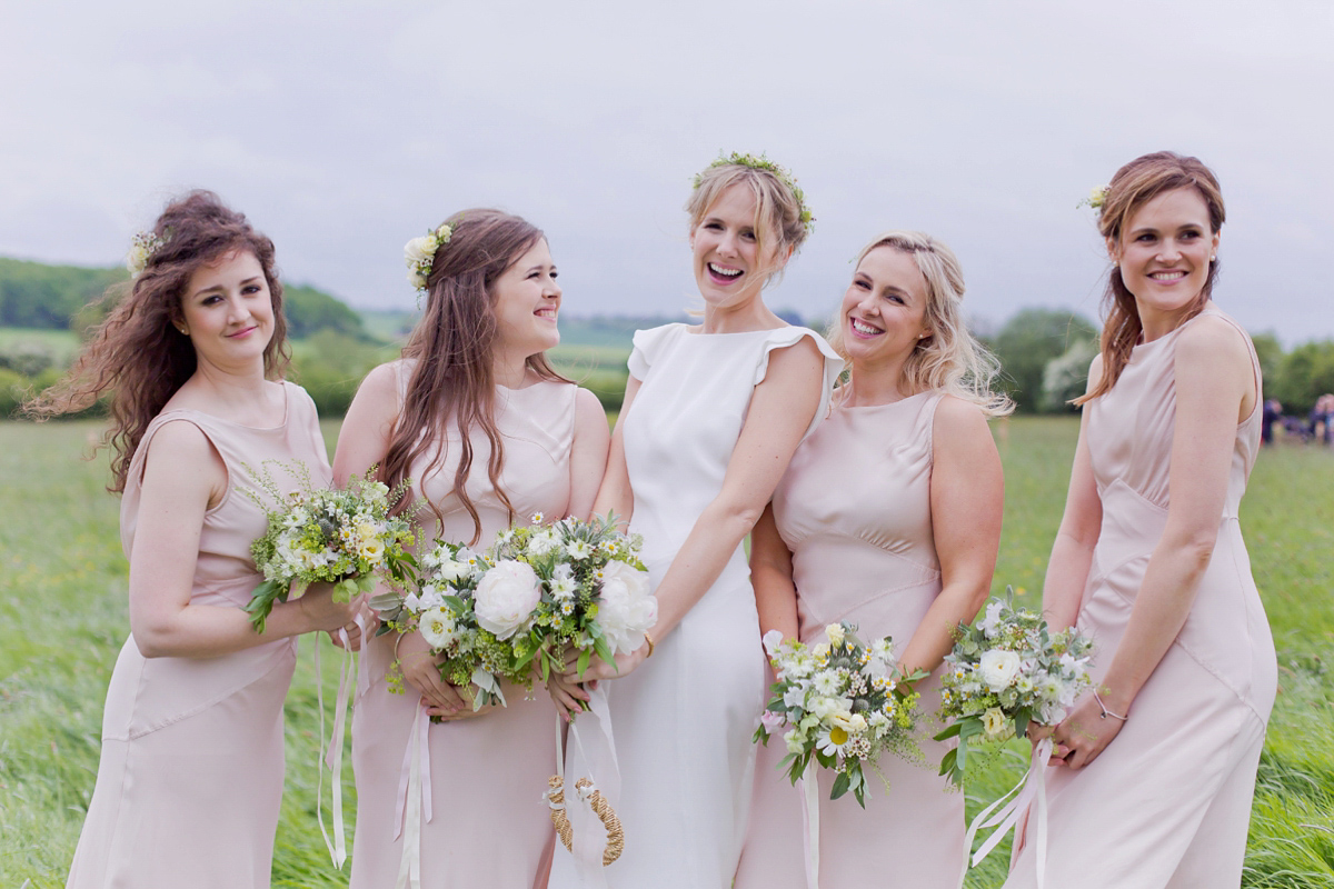 Connie wore a black leather jacket and dress by Belle & Bunty for her English wildfllower meadow inspired wedding. Photography by Emma Sekhonn.