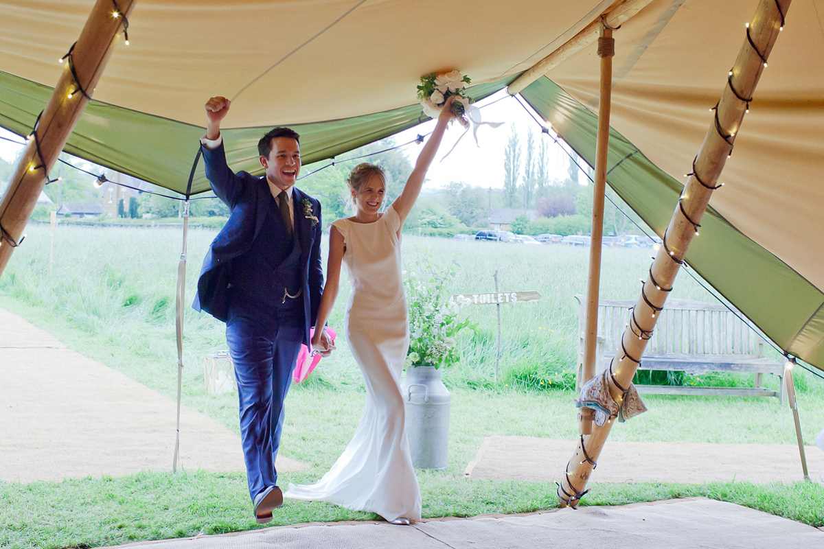 Connie wore a black leather jacket and dress by Belle & Bunty for her English wildfllower meadow inspired wedding. Photography by Emma Sekhonn.