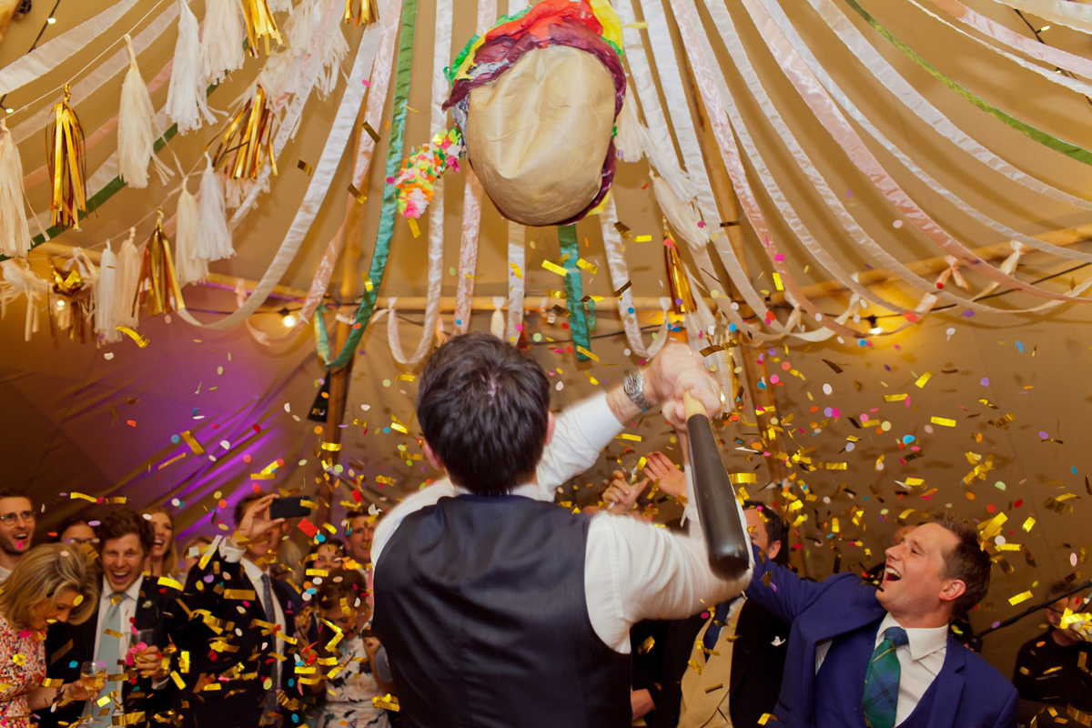 Connie wore a black leather jacket and dress by Belle & Bunty for her English wildfllower meadow inspired wedding. Photography by Emma Sekhonn.