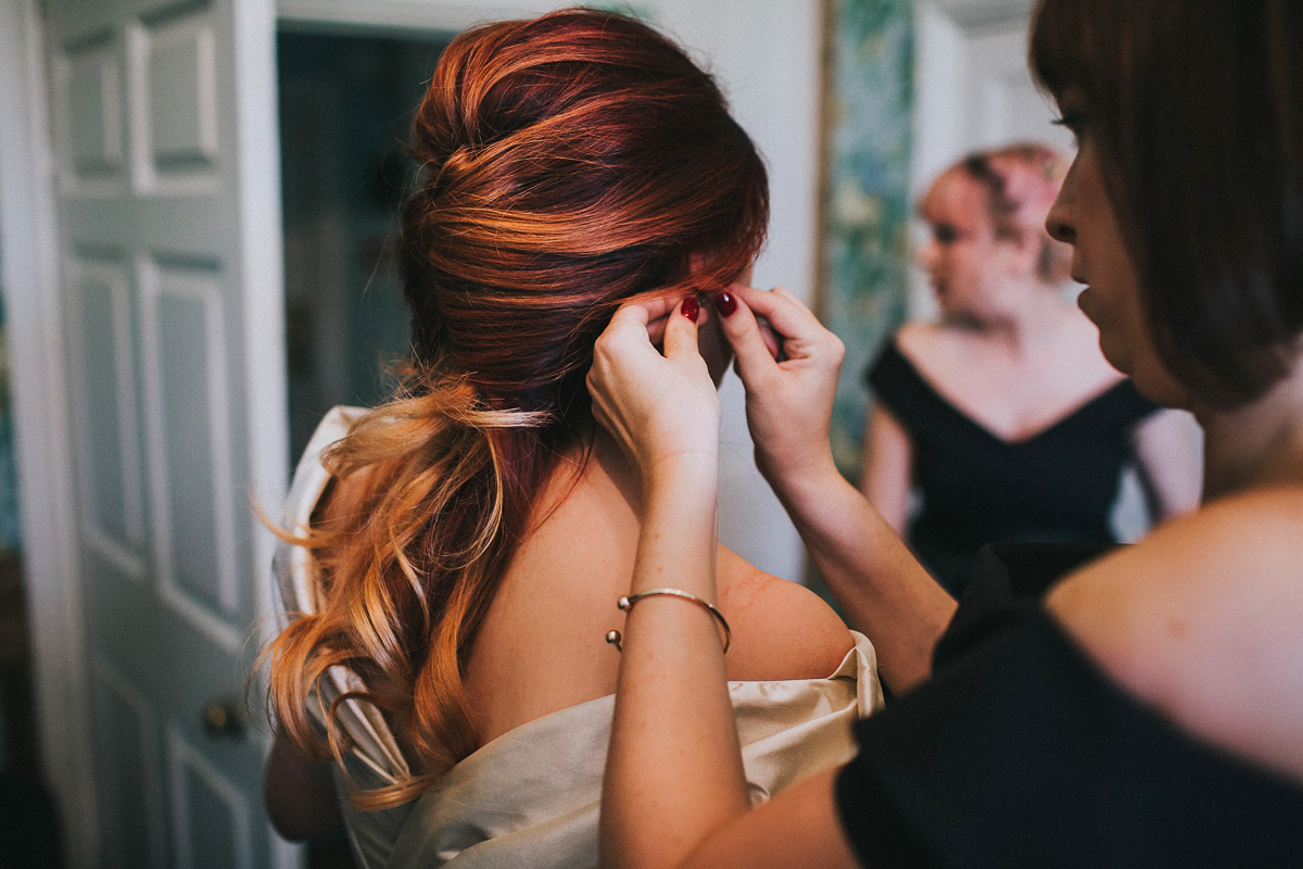 Bride Natasha wore a gown inspired by the dress worn by Dita von Teese for her wedding to Marilyn Manson. Natasha and Ian's wedding was full of Autumnal, gothic romance. Photography by Matt Horan.