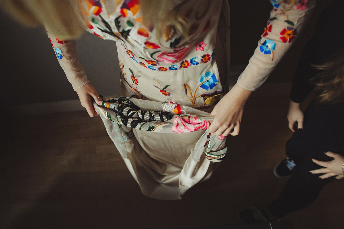 Gillian wore a colourful embroidered long sleeved gown by Temperley for her modern and alternative Woodside Warehouse wedding in Glasgow. Photography by Dan O'Day.