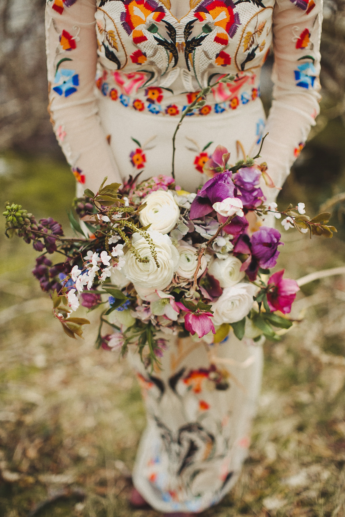 Gillian wore a colourful embroidered long sleeved gown by Temperley for her modern and alternative Woodside Warehouse wedding in Glasgow. Photography by Dan O'Day.