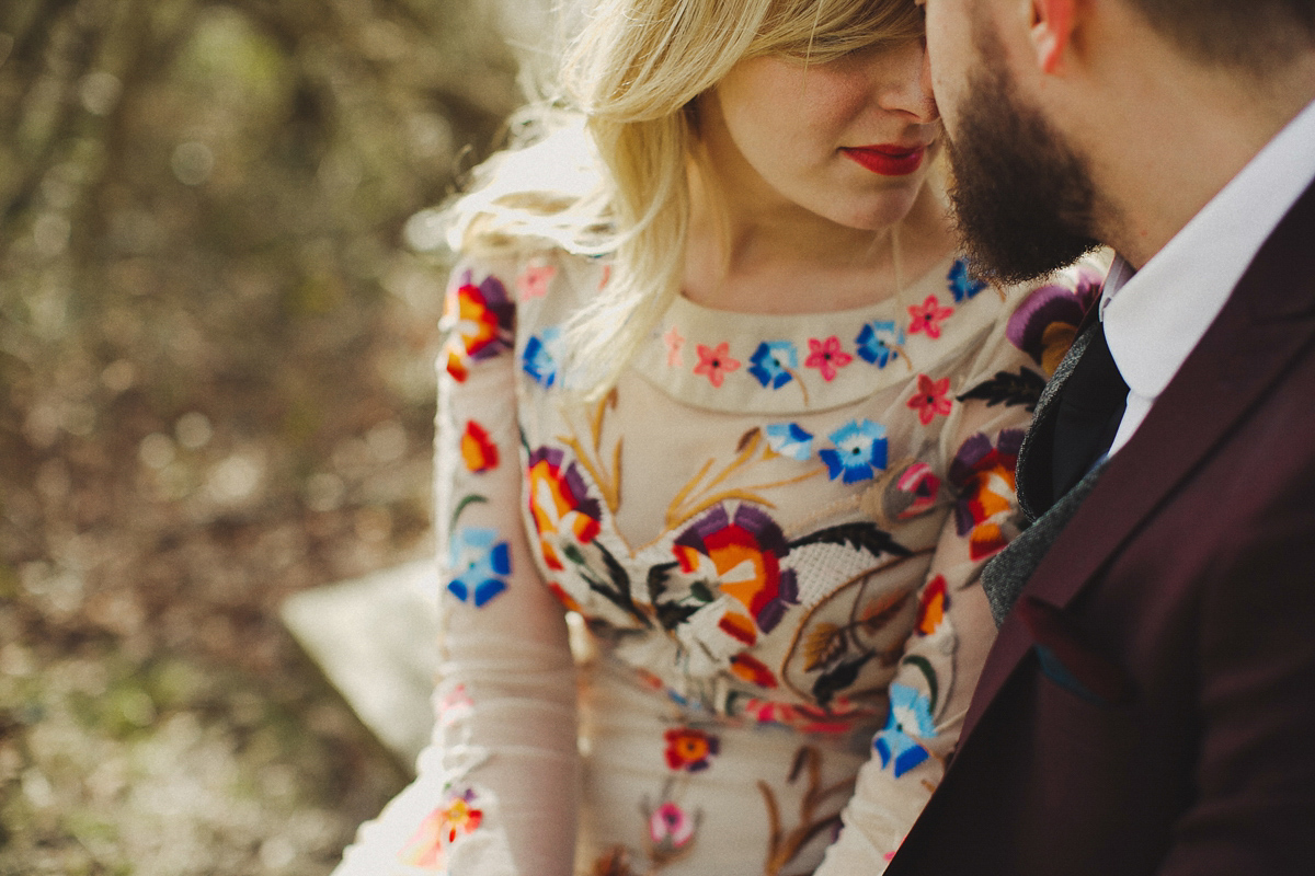 Gillian wore a colourful embroidered long sleeved gown by Temperley for her modern and alternative Woodside Warehouse wedding in Glasgow. Photography by Dan O'Day.